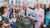 Prince Charles holding a hand-knitted Fair Isle jumper at a Welsh farmers market during his 2001 visit to Garthenor Organic